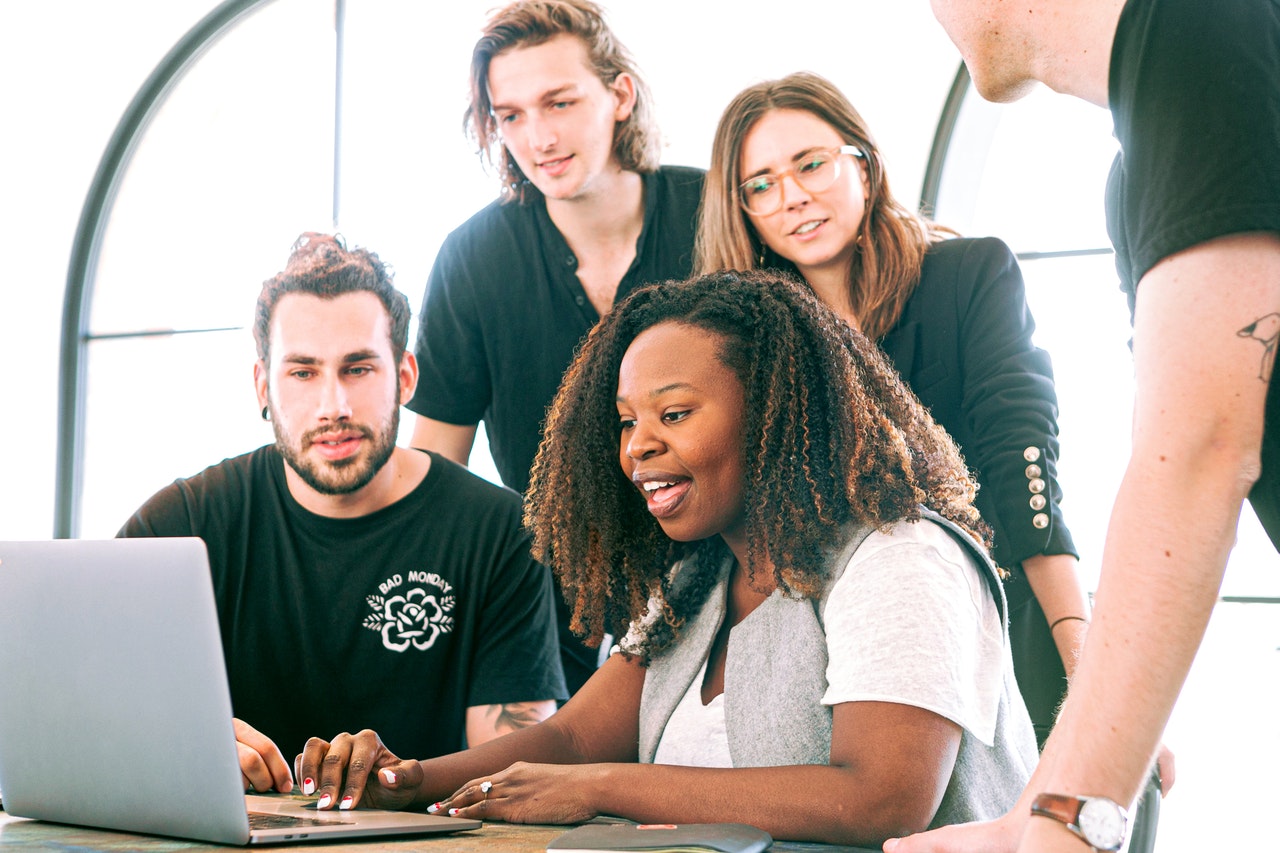 Image of a happy team working over a computer